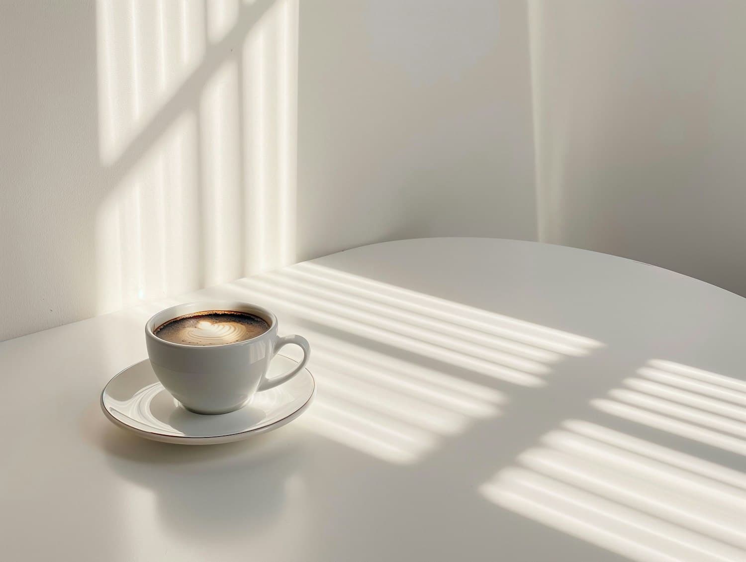 Emberwood Latte with latte art in a white cup on a sunlit table